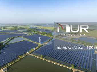 Photovoltaic panels are lining up in an ecological fish pond in Quyang town, Lianyungang, China, on May 13, 2024. (