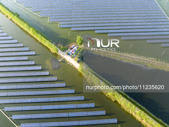 Photovoltaic panels are lining up in an ecological fish pond in Quyang town, Lianyungang, China, on May 13, 2024. 