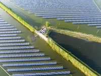 Photovoltaic panels are lining up in an ecological fish pond in Quyang town, Lianyungang, China, on May 13, 2024. (