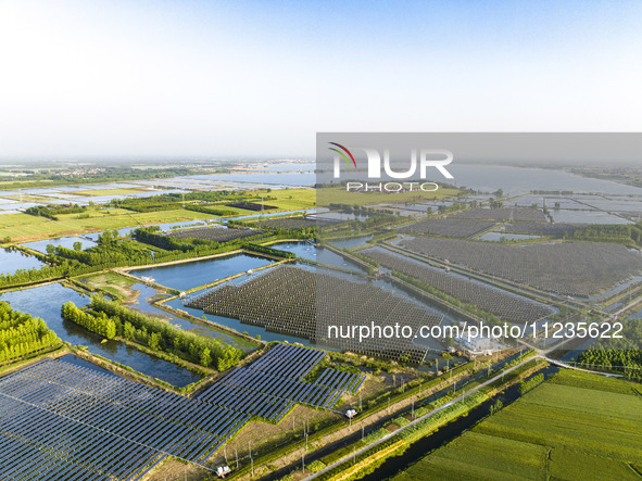 Photovoltaic panels are lining up in an ecological fish pond in Quyang town, Lianyungang, China, on May 13, 2024. 