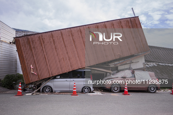 Collapsed houses and damaged cars are seen in the eastern Kumamoto suburb of Mashiki and neighboring areas, one month after a series of deva...