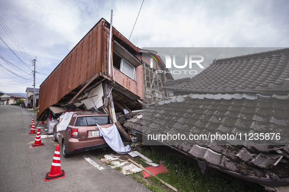 Collapsed houses and damaged cars are seen in the eastern Kumamoto suburb of Mashiki and neighboring areas, one month after a series of deva...