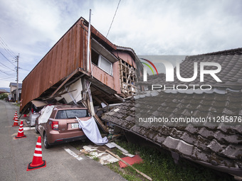 Collapsed houses and damaged cars are seen in the eastern Kumamoto suburb of Mashiki and neighboring areas, one month after a series of deva...