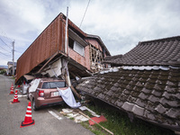 Collapsed houses and damaged cars are seen in the eastern Kumamoto suburb of Mashiki and neighboring areas, one month after a series of deva...