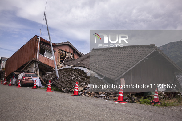 Collapsed houses and damaged cars are seen in the eastern Kumamoto suburb of Mashiki and neighboring areas, one month after a series of deva...