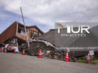 Collapsed houses and damaged cars are seen in the eastern Kumamoto suburb of Mashiki and neighboring areas, one month after a series of deva...