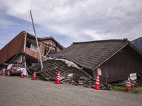 Collapsed houses and damaged cars are seen in the eastern Kumamoto suburb of Mashiki and neighboring areas, one month after a series of deva...