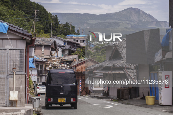 Collapsed houses and damaged cars are seen in the eastern Kumamoto suburb of Mashiki and neighboring areas, one month after a series of deva...