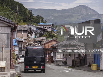 Collapsed houses and damaged cars are seen in the eastern Kumamoto suburb of Mashiki and neighboring areas, one month after a series of deva...