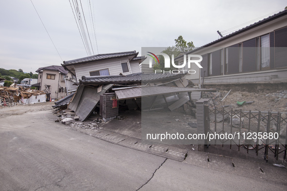 Collapsed houses are seen one month after a series of devastating earthquakes struck the eastern Kumamoto suburb of Mashiki and neighboring...