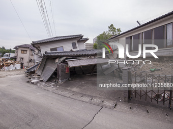 Collapsed houses are seen one month after a series of devastating earthquakes struck the eastern Kumamoto suburb of Mashiki and neighboring...