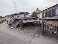 Collapsed houses are seen one month after a series of devastating earthquakes struck the eastern Kumamoto suburb of Mashiki and neighboring...