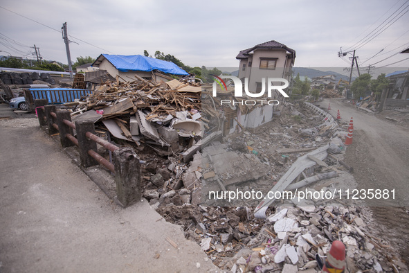 Collapsed houses are seen one month after a series of devastating earthquakes struck the eastern Kumamoto suburb of Mashiki and neighboring...