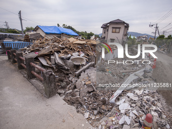 Collapsed houses are seen one month after a series of devastating earthquakes struck the eastern Kumamoto suburb of Mashiki and neighboring...