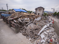 Collapsed houses are seen one month after a series of devastating earthquakes struck the eastern Kumamoto suburb of Mashiki and neighboring...