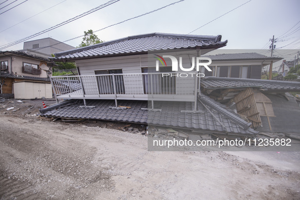 Collapsed houses are seen one month after a series of devastating earthquakes struck the eastern Kumamoto suburb of Mashiki and neighboring...