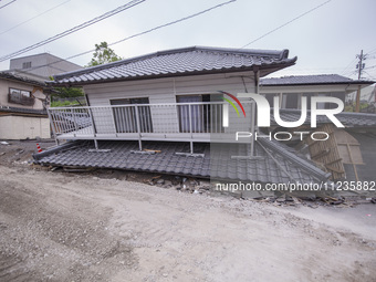 Collapsed houses are seen one month after a series of devastating earthquakes struck the eastern Kumamoto suburb of Mashiki and neighboring...