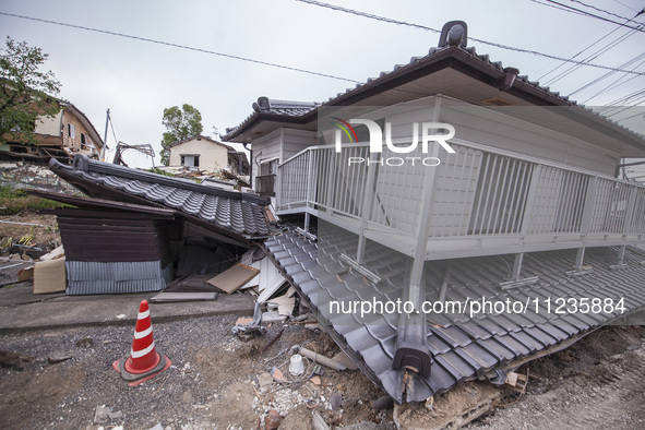 Collapsed houses are seen one month after a series of devastating earthquakes struck the eastern Kumamoto suburb of Mashiki and neighboring...