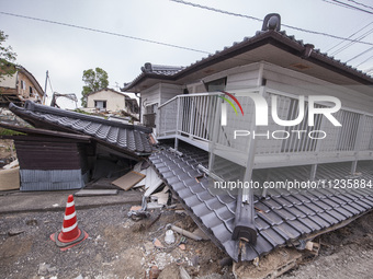 Collapsed houses are seen one month after a series of devastating earthquakes struck the eastern Kumamoto suburb of Mashiki and neighboring...