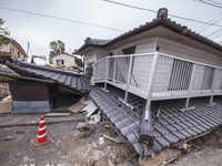 Collapsed houses are seen one month after a series of devastating earthquakes struck the eastern Kumamoto suburb of Mashiki and neighboring...