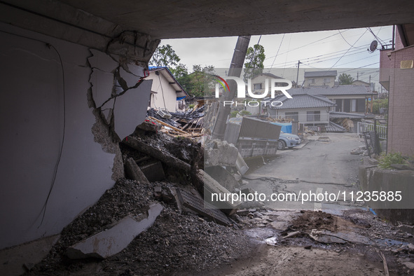 Collapsed houses are seen one month after a series of devastating earthquakes struck the eastern Kumamoto suburb of Mashiki and neighboring...