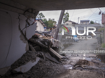 Collapsed houses are seen one month after a series of devastating earthquakes struck the eastern Kumamoto suburb of Mashiki and neighboring...