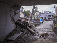 Collapsed houses are seen one month after a series of devastating earthquakes struck the eastern Kumamoto suburb of Mashiki and neighboring...