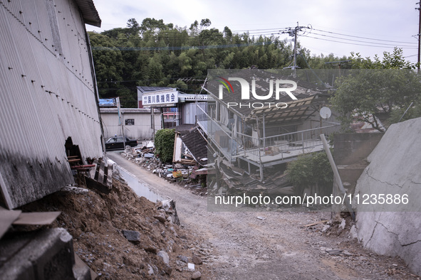 Collapsed houses are seen one month after a series of devastating earthquakes struck the eastern Kumamoto suburb of Mashiki and neighboring...