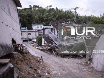 Collapsed houses are seen one month after a series of devastating earthquakes struck the eastern Kumamoto suburb of Mashiki and neighboring...