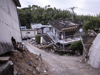 Collapsed houses are seen one month after a series of devastating earthquakes struck the eastern Kumamoto suburb of Mashiki and neighboring...