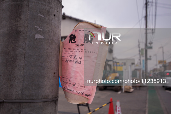 ''Unsafe'' notices are being placed on every damaged building in Mashiki, Kumamoto, Japan, on May 21, 2016, one month after a series of deva...