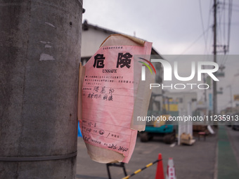 ''Unsafe'' notices are being placed on every damaged building in Mashiki, Kumamoto, Japan, on May 21, 2016, one month after a series of deva...