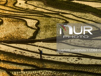 Villagers are working in a terraced field in Shiyuan village of Bijie city, Southwest China's Guizhou province, on May 13, 2024. (