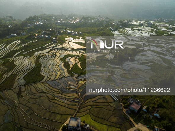 Villagers are working in a terraced field in Shiyuan village of Bijie city, Southwest China's Guizhou province, on May 13, 2024. 