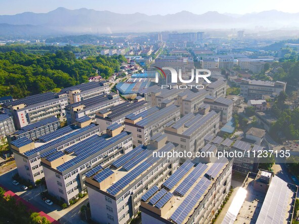 Photovoltaic panels are being seen on the roofs of enterprises in Lianyun township, Anqing city, Anhui province, China, on May 14, 2024. 