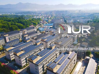 Photovoltaic panels are being seen on the roofs of enterprises in Lianyun township, Anqing city, Anhui province, China, on May 14, 2024. (