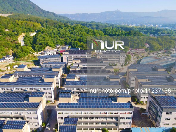 Photovoltaic panels are being seen on the roofs of enterprises in Lianyun township, Anqing city, Anhui province, China, on May 14, 2024. 