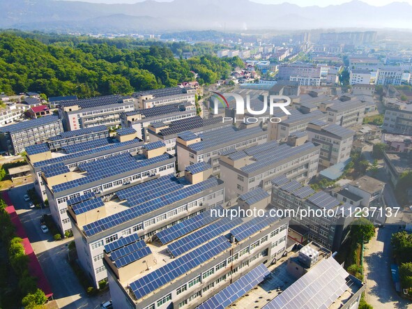 Photovoltaic panels are being seen on the roofs of enterprises in Lianyun township, Anqing city, Anhui province, China, on May 14, 2024. 