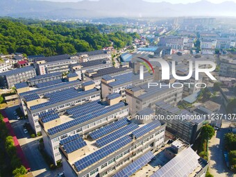 Photovoltaic panels are being seen on the roofs of enterprises in Lianyun township, Anqing city, Anhui province, China, on May 14, 2024. (