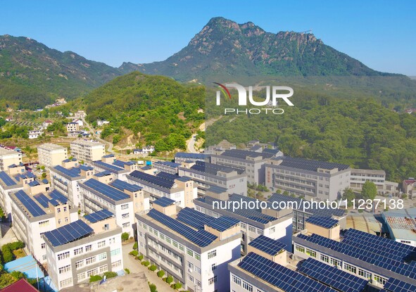 Photovoltaic panels are being seen on the roofs of enterprises in Lianyun township, Anqing city, Anhui province, China, on May 14, 2024. 