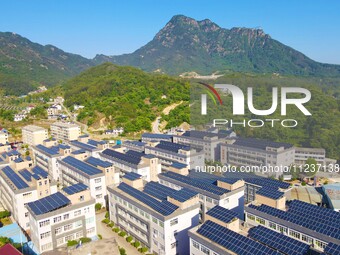 Photovoltaic panels are being seen on the roofs of enterprises in Lianyun township, Anqing city, Anhui province, China, on May 14, 2024. (