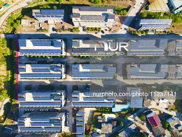 Photovoltaic panels are being seen on the roofs of enterprises in Lianyun township, Anqing city, Anhui province, China, on May 14, 2024. 