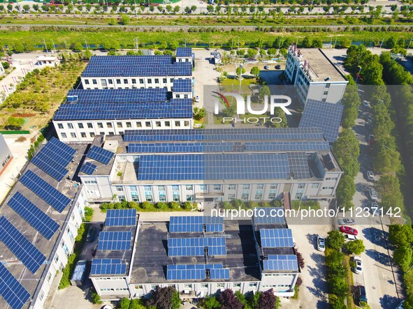 Photovoltaic panels are being seen on the roofs of enterprises in Lianyun township, Anqing city, Anhui province, China, on May 14, 2024. 