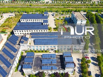 Photovoltaic panels are being seen on the roofs of enterprises in Lianyun township, Anqing city, Anhui province, China, on May 14, 2024. (