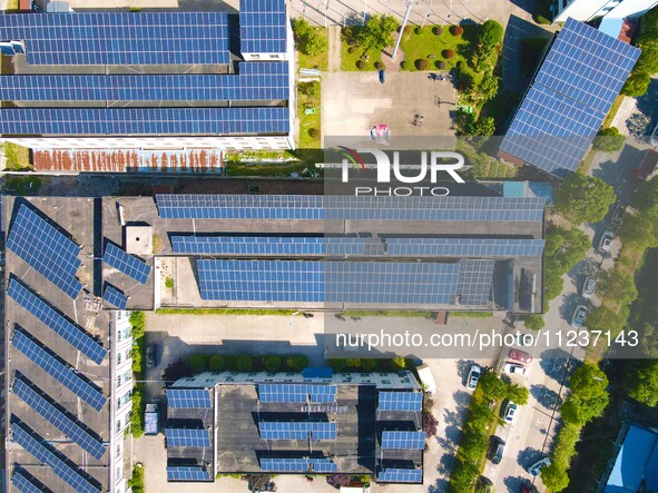 Photovoltaic panels are being seen on the roofs of enterprises in Lianyun township, Anqing city, Anhui province, China, on May 14, 2024. 