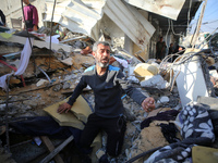 A Palestinian man is reacting as he searches for casualties at the site of an Israeli strike on a house, amid the ongoing conflict between I...