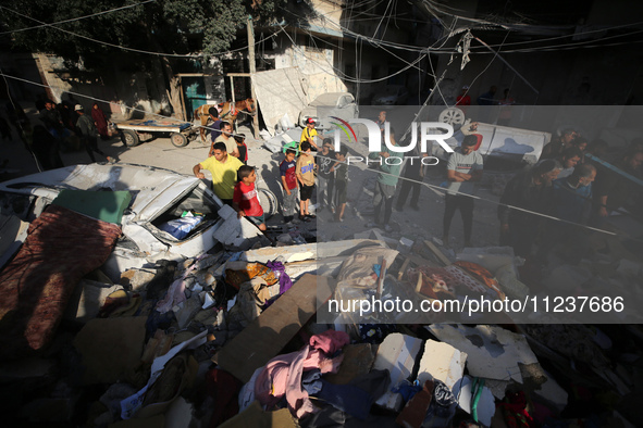 A Palestinian man is reacting as he searches for casualties at the site of an Israeli strike on a house, amid the ongoing conflict between I...