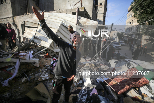 A Palestinian man is reacting as he searches for casualties at the site of an Israeli strike on a house, amid the ongoing conflict between I...