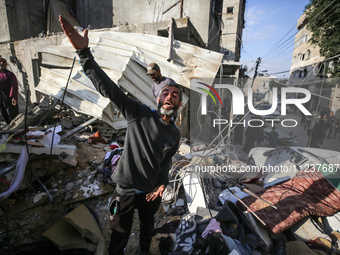 A Palestinian man is reacting as he searches for casualties at the site of an Israeli strike on a house, amid the ongoing conflict between I...