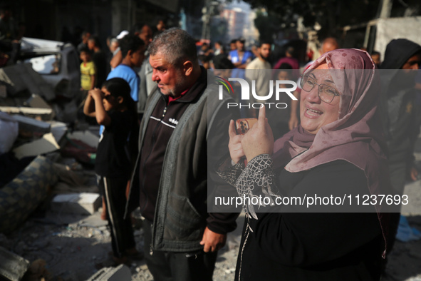 A Palestinian woman is reacting at the site of an Israeli strike on a house, amid the ongoing conflict between Israel and the Palestinian Is...